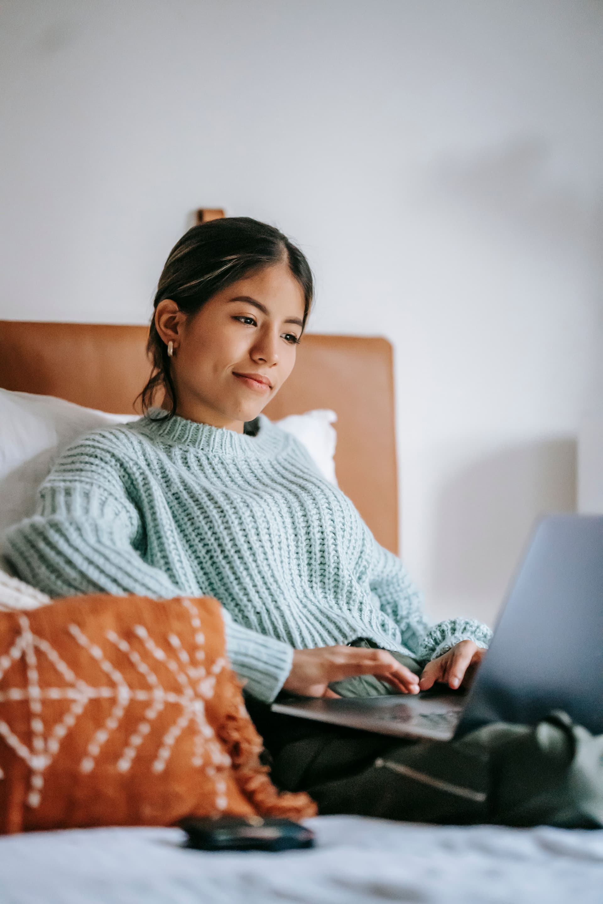 Woman joining online therapy from a comfortable home setting
